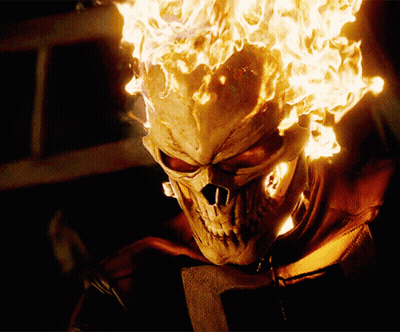 A Close Up Of A Skull With Flames Coming Out Of It 'S Head GIF