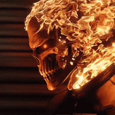 A Close Up Of A Skull With Flames Coming Out Of It 'S Head GIF