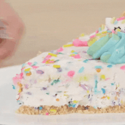 A Close Up Of A Slice Of Cake With Sprinkles On Top GIF