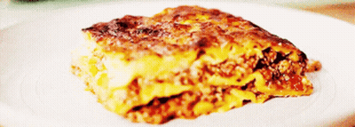 A Close Up Of A Slice Of Lasagna On A Plate GIF