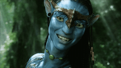 A Close Up Of A Smiling Avatar With Blue Skin GIF