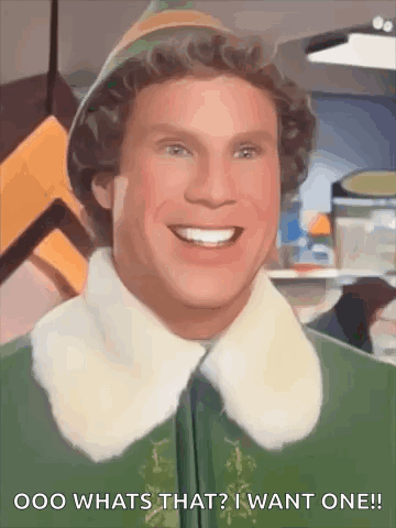 A Close Up Of A Smiling Elf With The Words `` What 'S That ? I Want One '' Written Below Him . GIF