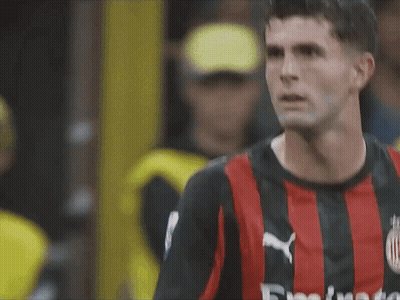 A Close Up Of A Soccer Player Wearing A Red And Black Jersey That Says Fly Emirates On It GIF