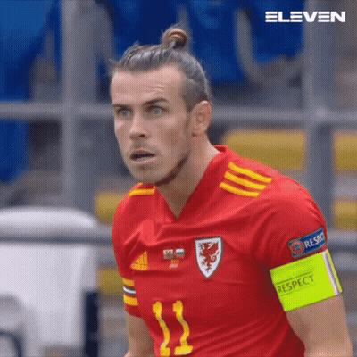 A Close Up Of A Soccer Player Wearing A Red Jersey With The Number 11 On It GIF