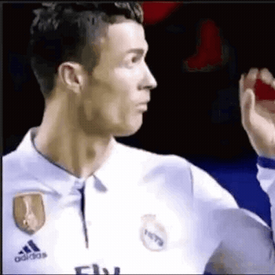 A Close Up Of A Soccer Player Wearing A White Adidas Jersey . GIF
