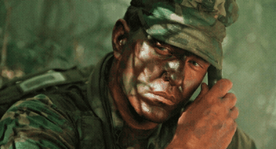 A Close Up Of A Soldier 'S Face With A Camouflage Uniform GIF
