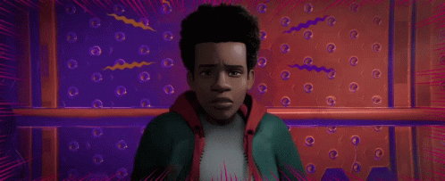 A Close Up Of A Spider Man 'S Face In A Red And Blue Room . GIF