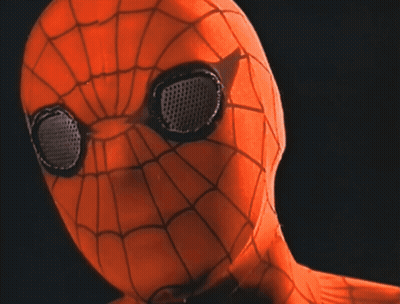 A Close Up Of A Spider Man 'S Face With Black Eyes GIF