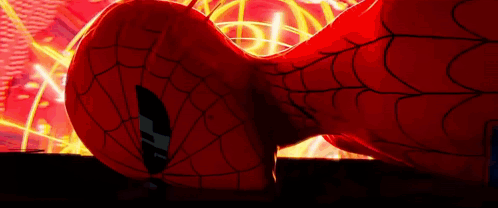 A Close Up Of A Spider Man 'S Head With A Spider Web Behind Him . GIF