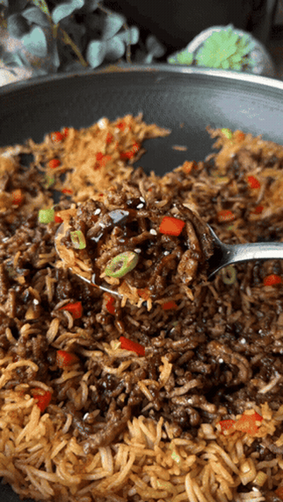 A Close Up Of A Spoon In A Pan Of Food GIF