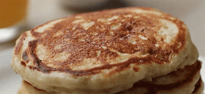 A Close Up Of A Stack Of Pancakes On A Table GIF
