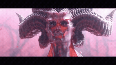 A Close Up Of A Statue Of A Demon With Horns On His Head . GIF