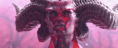 A Close Up Of A Statue Of A Demon With Red Horns . GIF