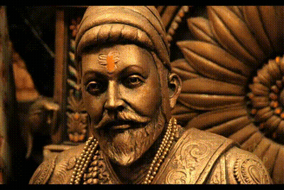 A Close Up Of A Statue Of A Man With A Beard And A Red Bindi On His Forehead GIF