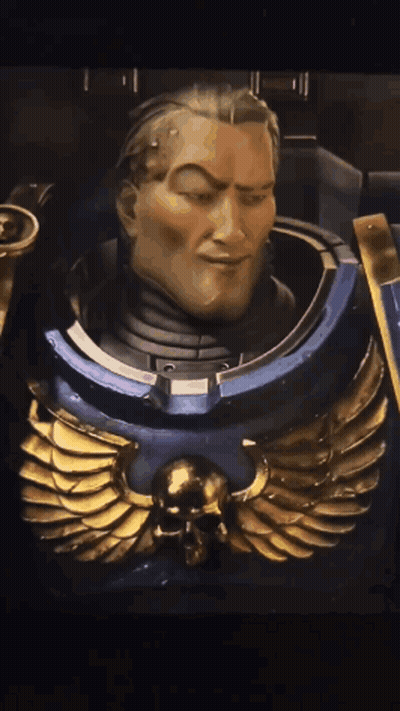 A Close Up Of A Statue Of A Man With A Skull And Wings On His Chest GIF
