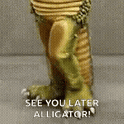 A Close Up Of A Statue Of An Alligator With The Words `` See You Later Alligator '' Written On It . GIF