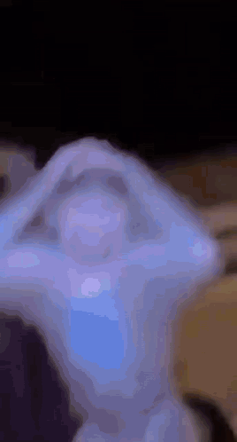 A Close Up Of A Statue With A Blue Light Coming Out Of It 'S Eyes . GIF