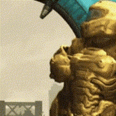 A Close Up Of A Statue With A Building In The Background With The Letter X On It GIF