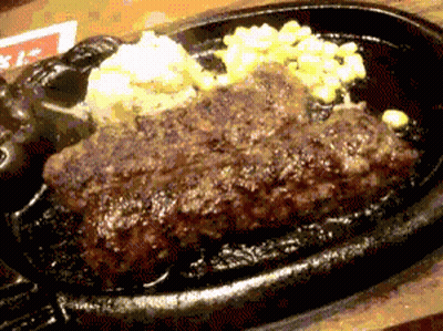 A Close Up Of A Steak On A Sizzling Plate GIF