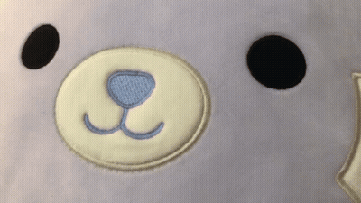 A Close Up Of A Stuffed Animal 'S Face With A Blue Nose GIF