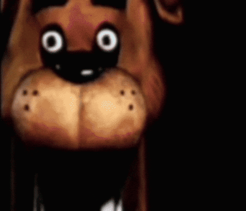 A Close Up Of A Stuffed Animal 'S Face With Big Eyes . GIF