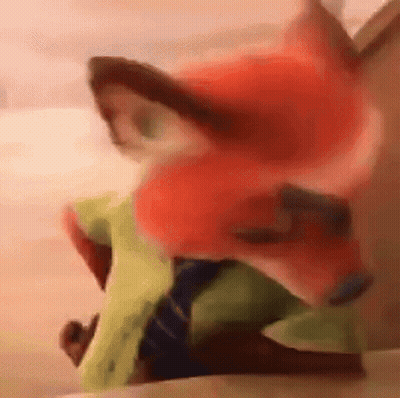 A Close Up Of A Stuffed Animal With A Fox 'S Face On It . GIF