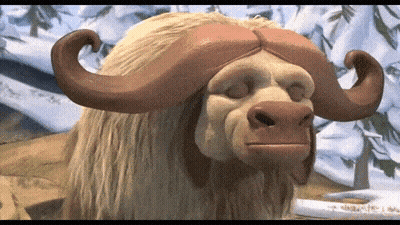 A Close Up Of A Stuffed Animal With Large Horns Looking At The Camera GIF