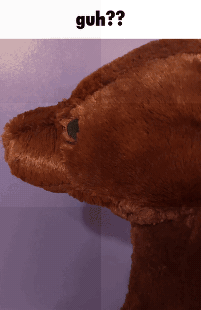 A Close Up Of A Stuffed Animal With The Word Guh On The Bottom GIF