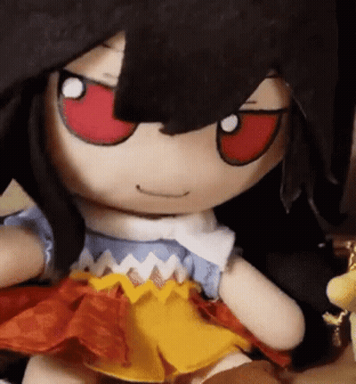 A Close Up Of A Stuffed Doll With Red Eyes . GIF