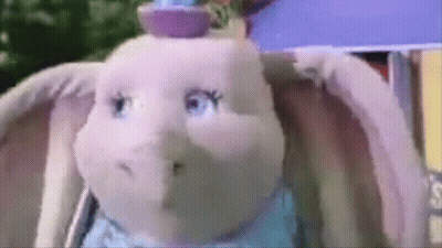 A Close Up Of A Stuffed Elephant With A Hat On GIF