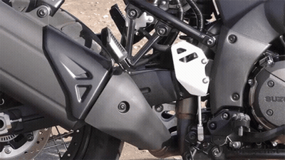 A Close Up Of A Suzuki Motorcycle Engine And Exhaust GIF