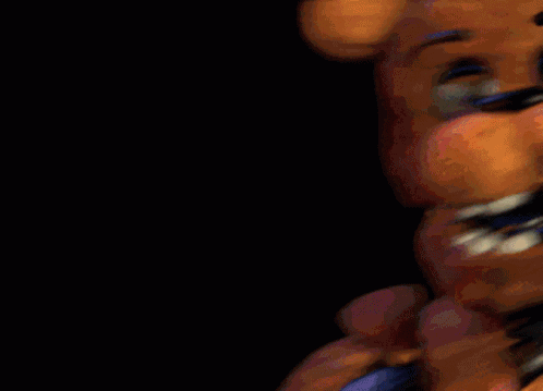 A Close Up Of A Teddy Bear 'S Face With A Black Background GIF