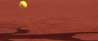 A Close Up Of A Tennis Racket Hitting A Tennis Ball On A Tennis Court . GIF