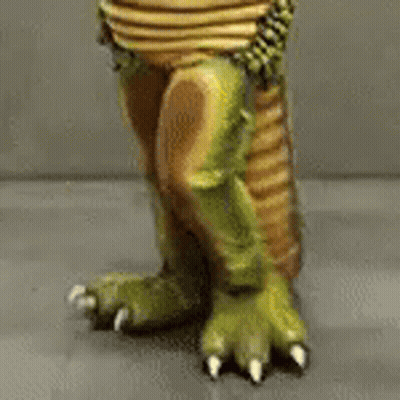 A Close Up Of A Toy Dinosaur 'S Feet And Claws . GIF