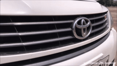 A Close Up Of A Toyota Emblem On A White Car GIF