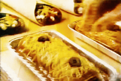 A Close Up Of A Tray Of Food With Cheese And Olives GIF
