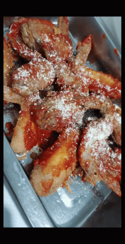 A Close Up Of A Tray Of Food With Sauce And Cheese GIF