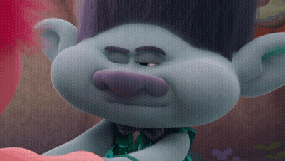 A Close Up Of A Troll With His Eyes Closed And A Bow Tie GIF