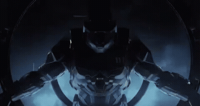 A Close Up Of A Video Game Character In A Futuristic Suit Standing In A Dark Room . GIF
