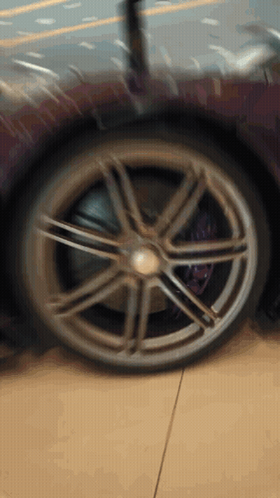 A Close Up Of A Wheel On A Purple Sports Car GIF