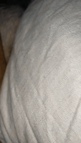 A Close Up Of A White Blanket With A Texture GIF