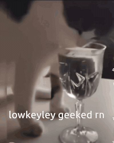 A Close Up Of A Wine Glass With The Words Lowkeyley Geeked Rn Below It GIF