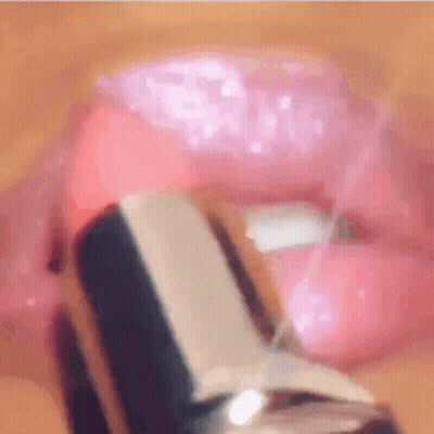 A Close Up Of A Woman Applying Pink Lipstick GIF