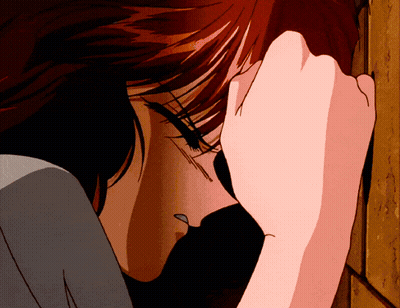 A Close Up Of A Woman Covering Her Face With Her Hand GIF