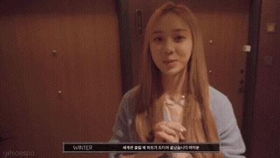 A Close Up Of A Woman Covering Her Mouth With Her Hands And A Gifsaespa Watermark GIF