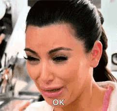 A Close Up Of A Woman Crying With The Word Ok Written On Her Face . GIF