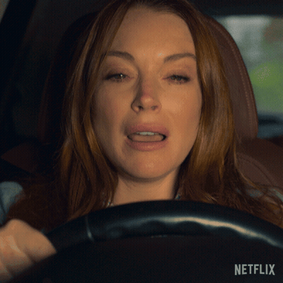A Close Up Of A Woman Driving A Car With Netflix Written On The Bottom GIF