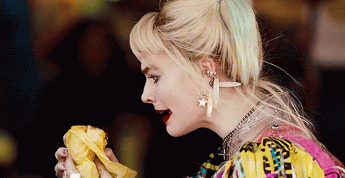 A Close Up Of A Woman Eating A Banana In A Movie . GIF