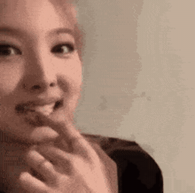 A Close Up Of A Woman Eating A Piece Of Food . GIF