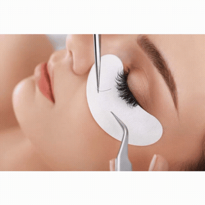 A Close Up Of A Woman Getting Her Eyelashes Extended GIF